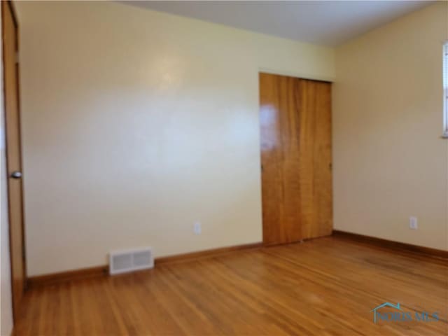 354 N River Rd, Waterville, OH 43566 - empty room with baseboards, visible vents, and wood finished floors