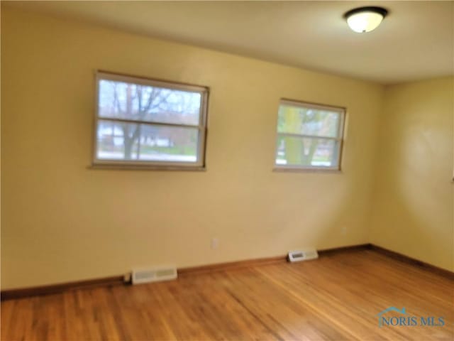 354 N River Rd, Waterville, OH 43566 - empty room with baseboards, visible vents, and wood finished floors