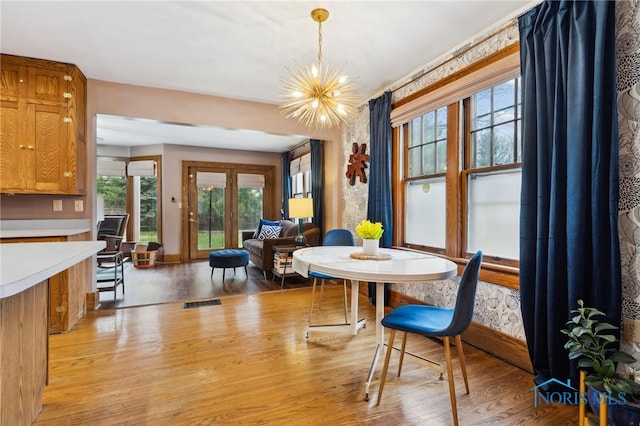 dining room with a notable chandelier and light wood-style floors