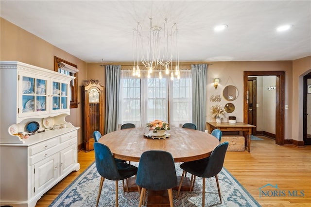 dining space with a notable chandelier, baseboards, light wood-style floors, and recessed lighting