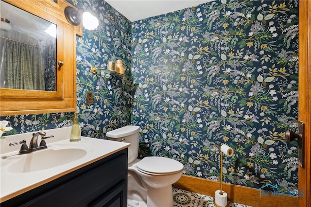 bathroom featuring wallpapered walls, toilet, and vanity