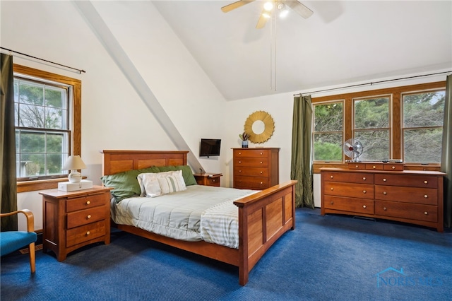 bedroom with lofted ceiling, ceiling fan, and dark colored carpet