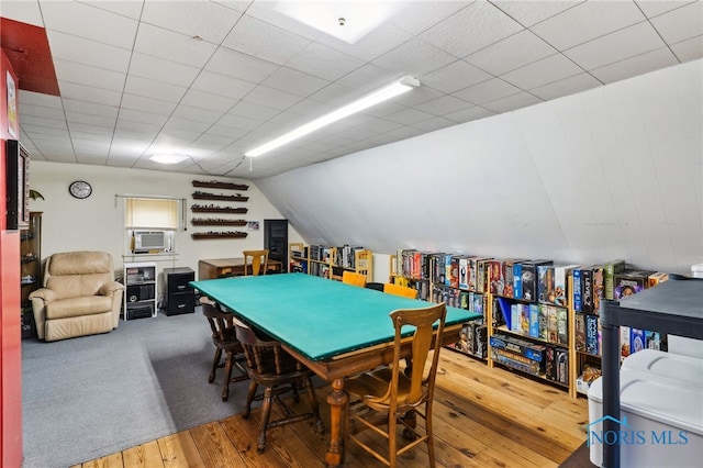 playroom with vaulted ceiling and wood-type flooring