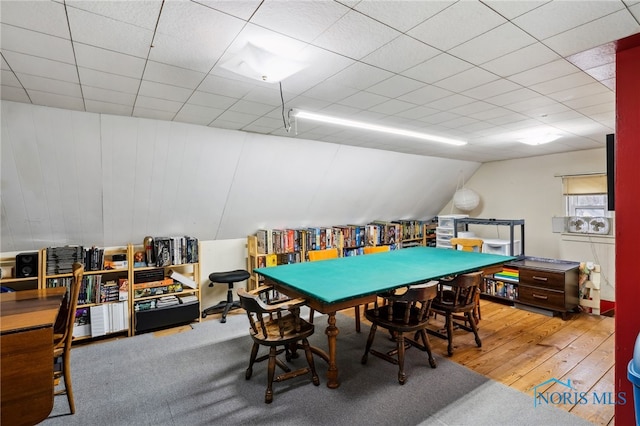 playroom featuring vaulted ceiling and wood finished floors