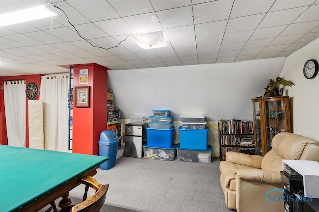 interior space with carpet floors and a drop ceiling