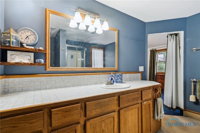 full bathroom with vanity and an enclosed shower
