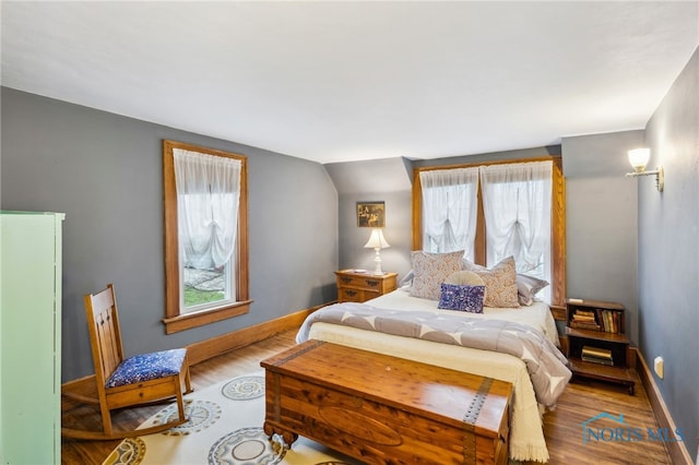 bedroom featuring baseboards and wood finished floors