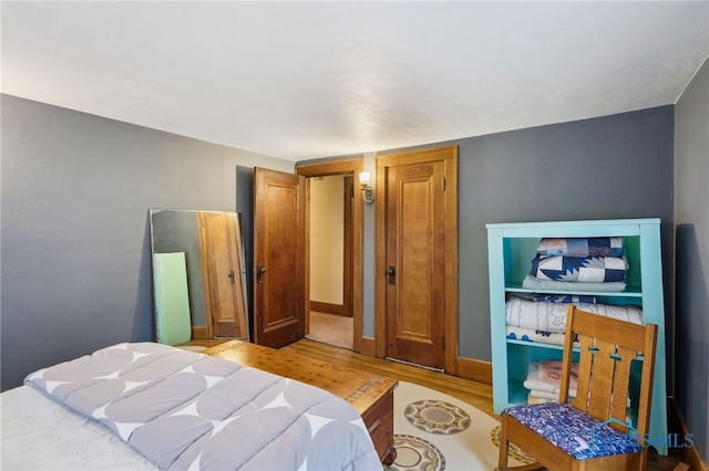 bedroom featuring baseboards and wood finished floors