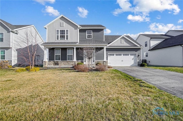 100 Bentley Dr, Perrysburg, OH 43551 - view of front of property with stone siding, an attached garage, a front lawn, board and batten siding, and driveway