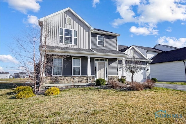 100 Bentley Dr, Perrysburg, OH 43551 - view of front of house with stone siding, aphalt driveway, a garage, a front lawn, and board and batten siding