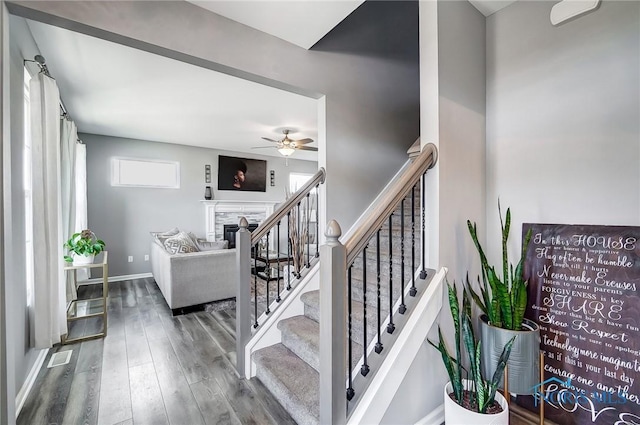 100 Bentley Dr, Perrysburg, OH 43551 - staircase with baseboards, a fireplace, wood finished floors, and a ceiling fan