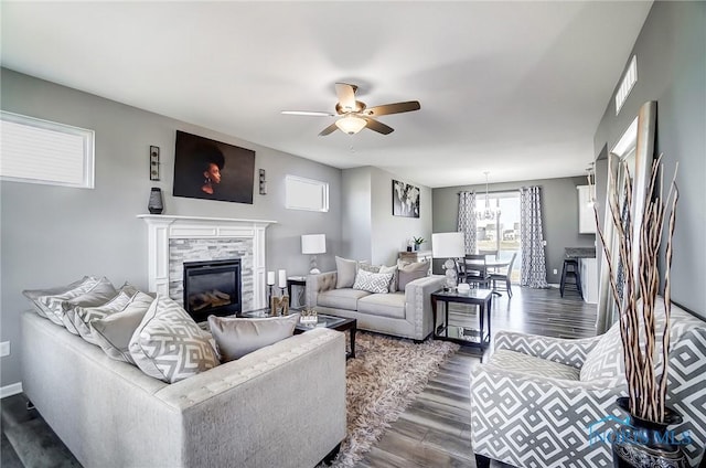 100 Bentley Dr, Perrysburg, OH 43551 - living room with a stone fireplace, dark wood-style floors, baseboards, visible vents, and ceiling fan