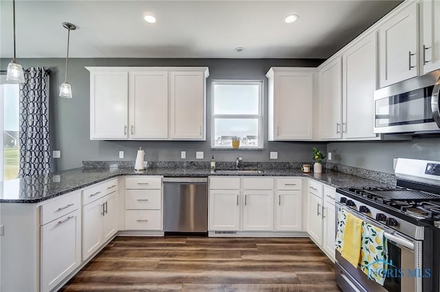 100 Bentley Dr, Perrysburg, OH 43551 - kitchen with white cabinets, a sink, appliances with stainless steel finishes, and a peninsula