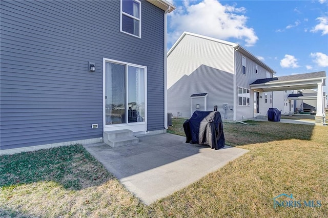 100 Bentley Dr, Perrysburg, OH 43551 - rear view of house with cooling unit, a yard, and a patio area