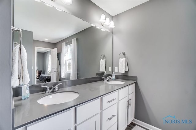 100 Bentley Dr, Perrysburg, OH 43551 - bathroom with double vanity, a sink, baseboards, and ensuite bath
