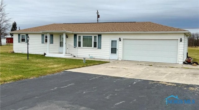 ranch-style house featuring driveway, an attached garage, and a front lawn