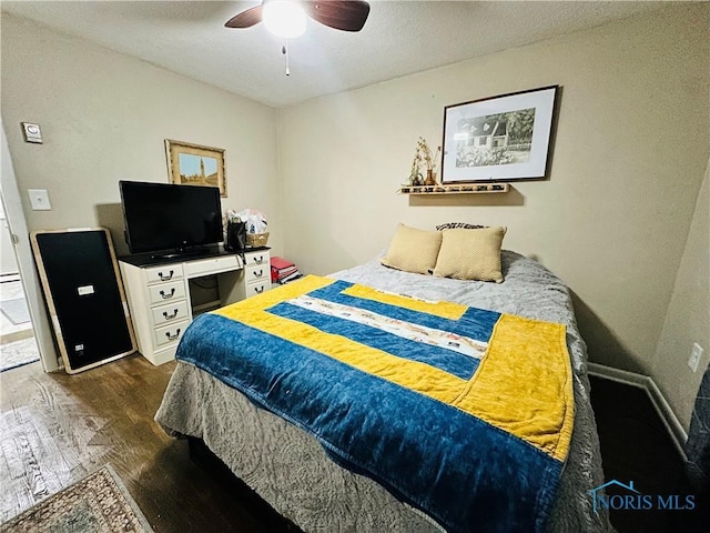 bedroom featuring a ceiling fan, a textured ceiling, and wood finished floors