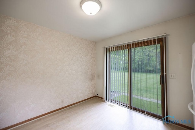 5644 Greenridge Dr Unit 5644, Toledo, OH 43615 - empty room with wallpapered walls and wood finished floors