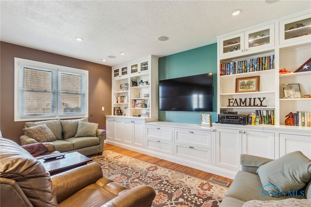 3114 Gleneagle Dr, Findlay, OH 45840 - living area featuring recessed lighting, a textured ceiling, and light wood finished floors