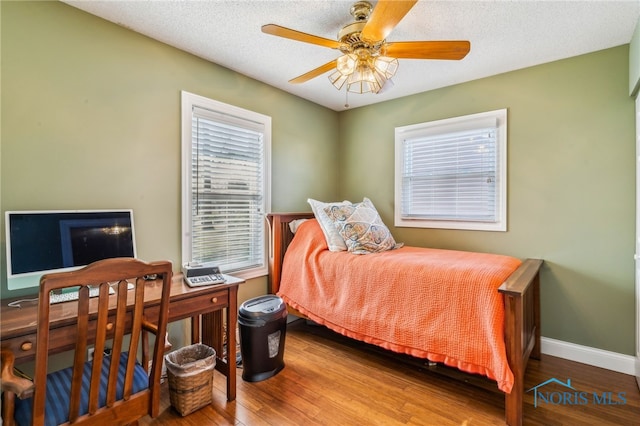 3114 Gleneagle Dr, Findlay, OH 45840 - bedroom featuring baseboards, ceiling fan, a textured ceiling, and wood finished floors
