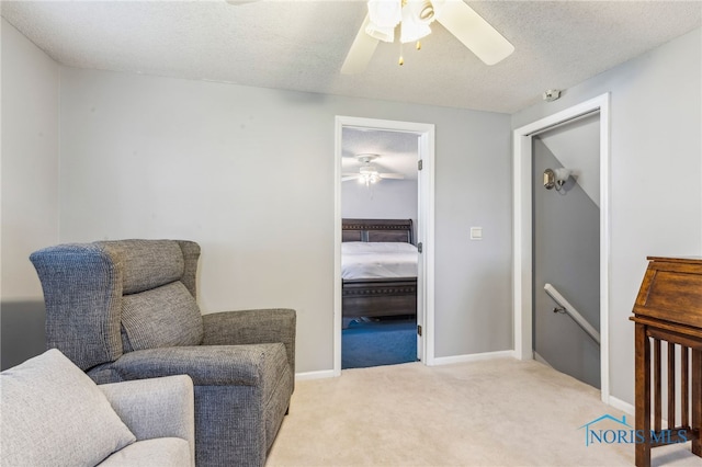 3114 Gleneagle Dr, Findlay, OH 45840 - living area featuring a ceiling fan, a textured ceiling, an upstairs landing, and light carpet