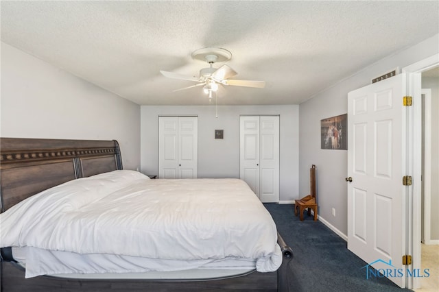 3114 Gleneagle Dr, Findlay, OH 45840 - bedroom with visible vents, multiple closets, dark colored carpet, baseboards, and a ceiling fan