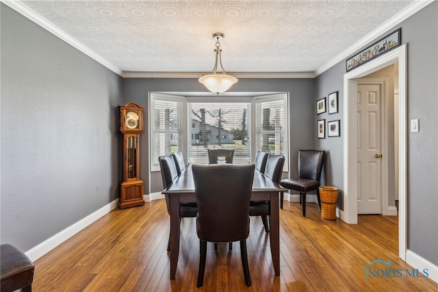 3114 Gleneagle Dr, Findlay, OH 45840 - dining space with baseboards, an ornate ceiling, ornamental molding, and hardwood / wood-style floors