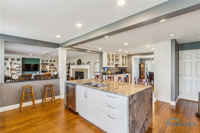 3114 Gleneagle Dr, Findlay, OH 45840 - kitchen with light stone countertops, open floor plan, white cabinetry, a sink, and dishwasher