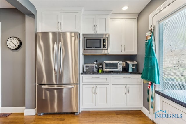 3114 Gleneagle Dr, Findlay, OH 45840 - kitchen with stainless steel appliances, light wood-type flooring, white cabinetry, and a toaster