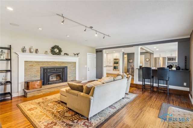 3114 Gleneagle Dr, Findlay, OH 45840 - living area featuring baseboards, a stone fireplace, recessed lighting, and wood finished floors