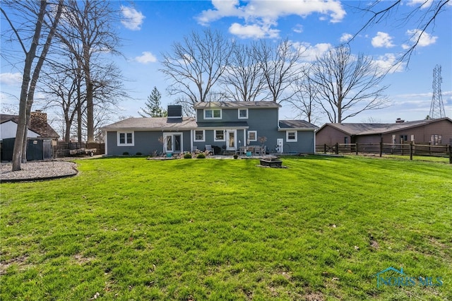 3114 Gleneagle Dr, Findlay, OH 45840 - rear view of house featuring a lawn, a patio, a fenced backyard, and an outdoor fire pit