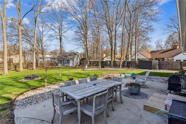 3114 Gleneagle Dr, Findlay, OH 45840 - view of patio featuring outdoor dining area, a fenced backyard, an outdoor fire pit, and an outbuilding