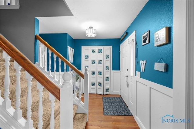 1823 Lexington Dr, Perrysburg, OH 43551 - entryway featuring a decorative wall, a wainscoted wall, stairs, and wood finished floors