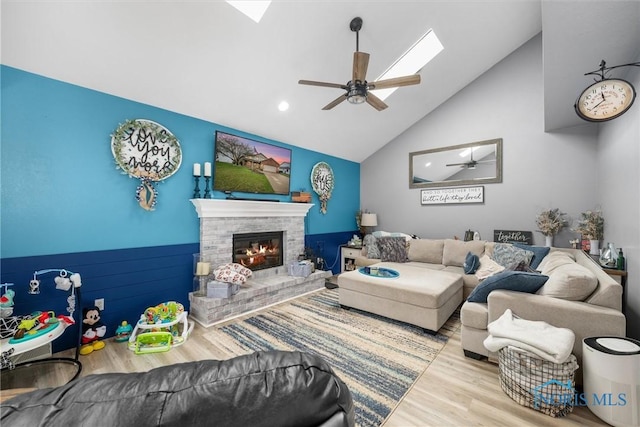 1823 Lexington Dr, Perrysburg, OH 43551 - living room with high vaulted ceiling, a ceiling fan, wood finished floors, a skylight, and a brick fireplace