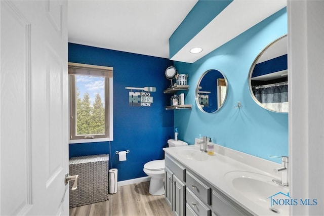 1823 Lexington Dr, Perrysburg, OH 43551 - full bath featuring baseboards, a sink, toilet, and wood finished floors