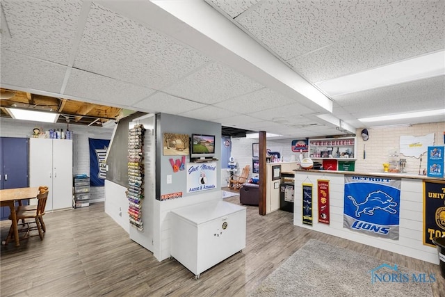 1823 Lexington Dr, Perrysburg, OH 43551 - finished basement featuring wood finished floors, a drop ceiling, and brick wall