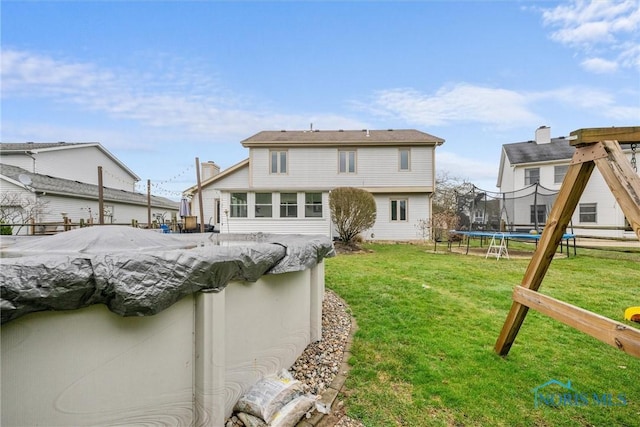 1823 Lexington Dr, Perrysburg, OH 43551 - back of property featuring a yard and a trampoline