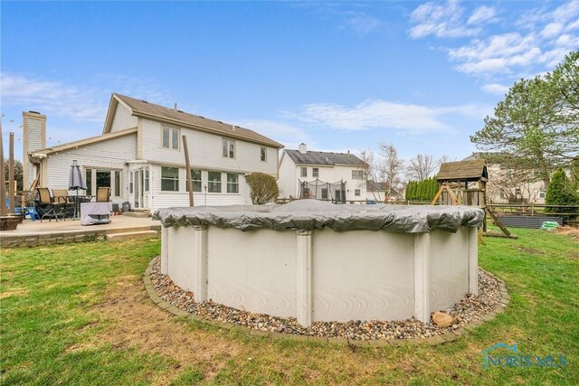 1823 Lexington Dr, Perrysburg, OH 43551 - back of house featuring a patio, fence, a covered pool, and a yard