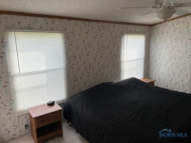 bedroom with wallpapered walls, light carpet, crown molding, and a textured ceiling