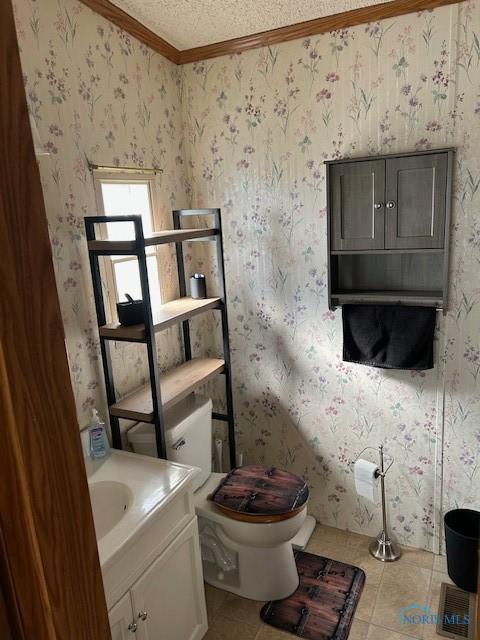 bathroom featuring a textured ceiling, wallpapered walls, tile patterned floors, and crown molding