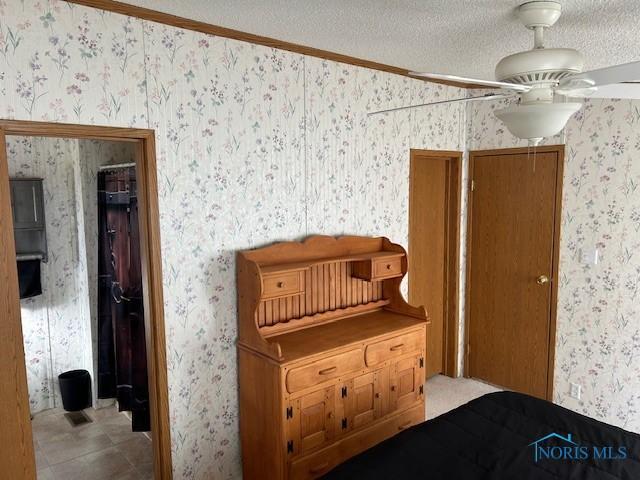 tiled bedroom featuring a textured ceiling and wallpapered walls