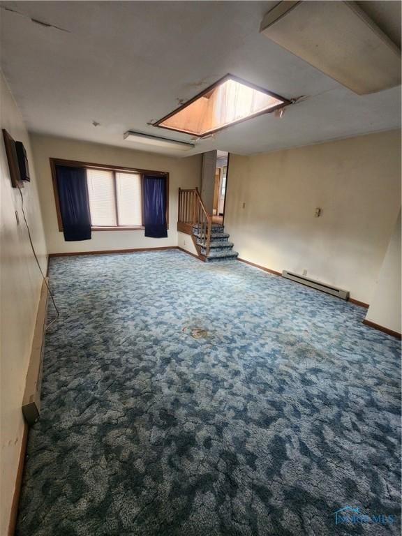 825 Park St, Findlay, OH 45840 - spare room featuring stairs, carpet floors, a skylight, baseboards, and a baseboard heating unit