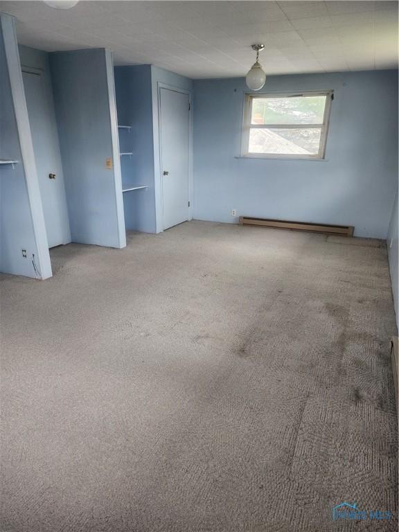825 Park St, Findlay, OH 45840 - carpeted spare room featuring a baseboard heating unit