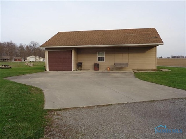 13837 Rd 12, Ottawa, OH 45875 - view of side of property with driveway, an attached garage, and a yard