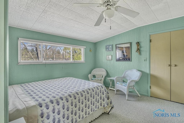 bedroom with a ceiling fan and carpet floors