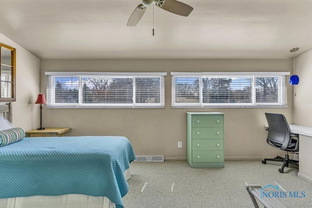 carpeted bedroom with baseboards, ceiling fan, and visible vents