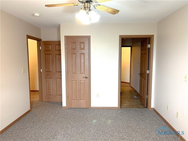 12783 Rd 82 Unit 1, Paulding, OH 45879 - unfurnished bedroom featuring baseboards, ceiling fan, and carpet