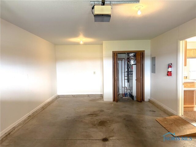 12783 Rd 82 Unit 1, Paulding, OH 45879 - garage with electric panel, baseboards, and a garage door opener