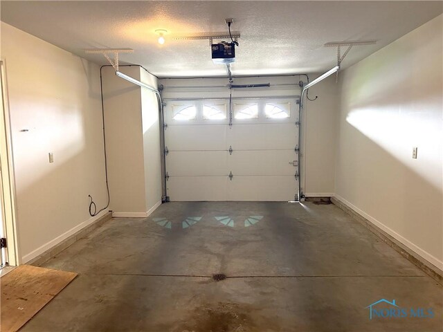 12783 Rd 82 Unit 1, Paulding, OH 45879 - garage with baseboards and a garage door opener