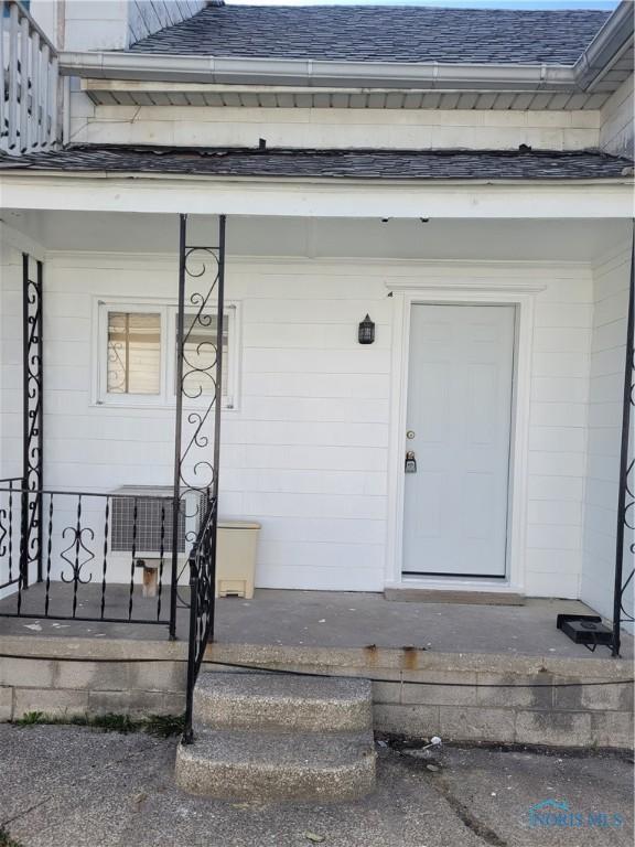 621 Nevada St, Toledo, OH 43605 - doorway to property with covered porch and roof with shingles